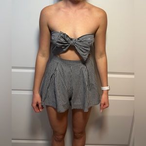 Black/white checkered patterned strapless romper with a front bow